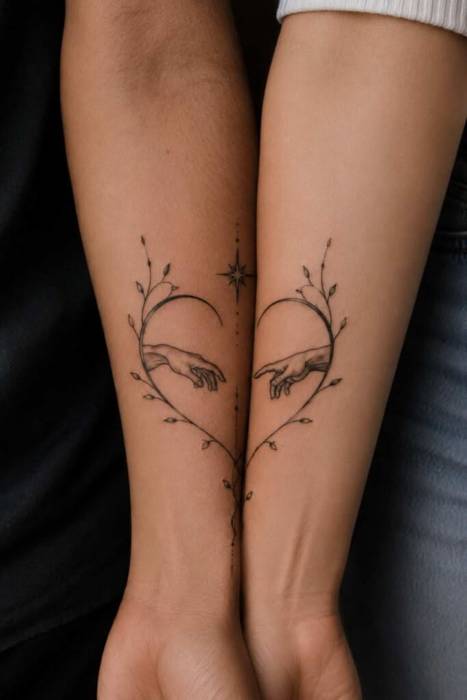 Half-heart tattoos with reaching hands, vines and a star that join when two forearms touch