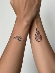 Matching forearm tattoos of a small ocean wave on one arm and a flame on the other