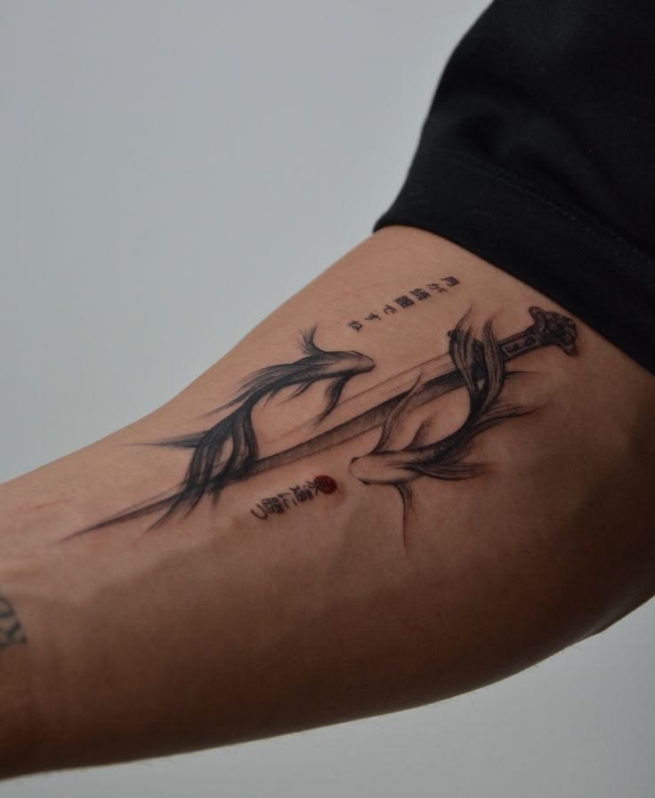 Ink-wash sword tattoo with two flowing koi fish and small calligraphy characters on a forearm