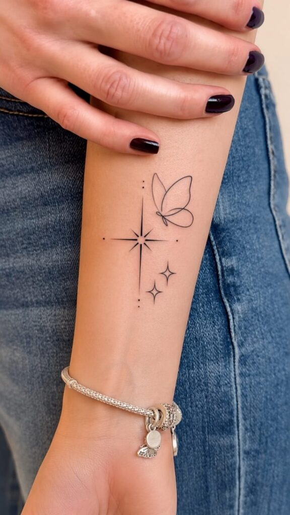 Fine-line butterfly with a large sparkle star and two small stars on the forearm