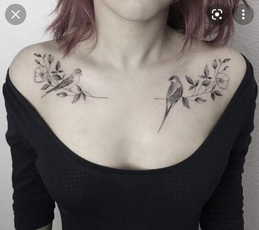 Symmetrical bird and flower branch tattoos on both collarbones of a woman